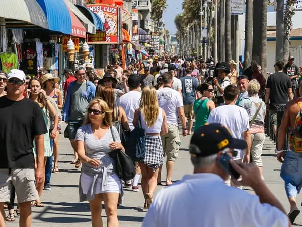 Pedestrianized street with a crowd of people and local businesses