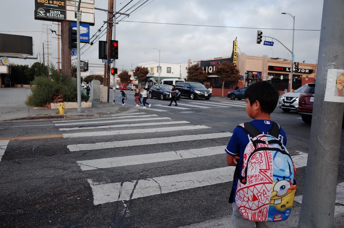 Two crosswalks with people crossing one of them