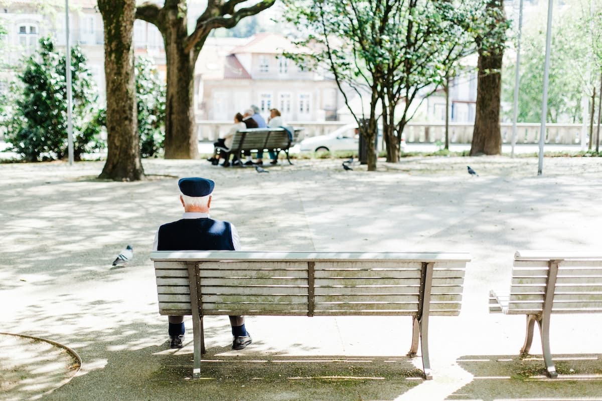 In a park, person sitting on a public bench